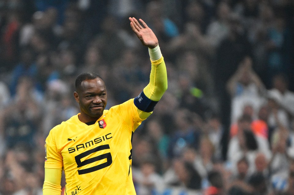 (FILES) Rennes' French goalkeeper #30 Steve Mandanda salutes the OM supporters after receiving the captain's armband at the end of their ligue 1 football match Olympic of Marseille (OM) against stade Rennais at the Velodrome stadium, in Marseille on May 17, 2025. International goalkeeper Steve Mandanda, world champion with the French team in 2018, announced at the age of 40 that he was calling time on his career in an interview with the newspaper L'Equipe on September 10, 2025. (Photo by Christophe SIMON / AFP) (Photo by CHRISTOPHE SIMON/AFP via Getty Images)